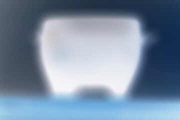 A blurry dreamy view of a soft glow of a pot shining in the darkness in a bright film negative.