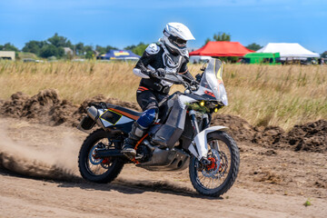 Motocross rider riding on extreme dust track