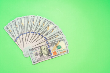 Money dollar bills on green background