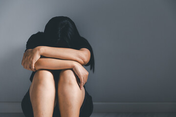 Young depressed woman, domestic and rape violence, beaten and raped sitting in the corner. The...