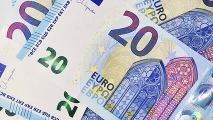 Overhead shot of twenty euro banknotes rotating clockwise. Euro money background. - Powered by Adobe