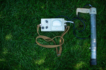 Soviet old dosimeter for measuring radiation on a green lawn