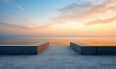 Empty concrete floor against the backdrop of the ocean at sunset.