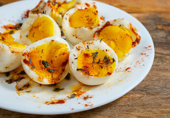 Soft boiled eggs with paprika and fresh thyme for simple breakfast.
