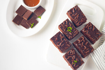 Delicious chocolate brownies with mint on white background. Sweet cake concept. 