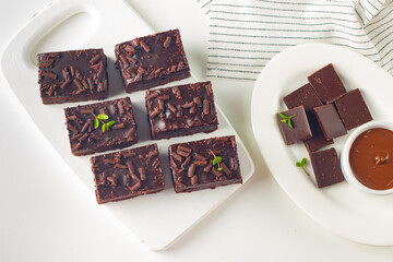 Delicious chocolate brownies with mint on white background. Sweet cake concept. 