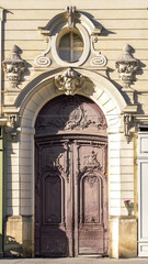 Paris, an ancient wooden door, beautiful facade in a luxury neighborhood, rue Saint-Dominique, in the 7e arrondissement
