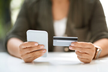 Woman hands holding credit card and smartphone, online shopping