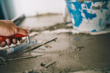 Mechanical man hand cement working interior plastering on floor