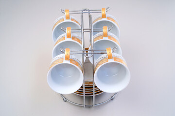 Plates and glasses cutlery on stand on white background