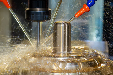 Close up scene the CNC milling machine cutting the shell mold parts with oil coolant method .