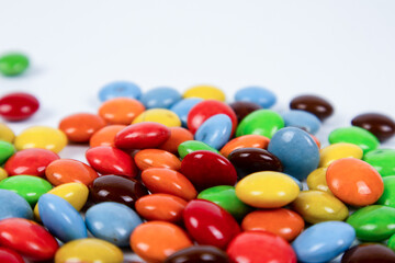 Fototapeta na wymiar pile of colorful chocolate candies on white background