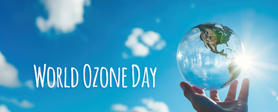 International Day for the Preservation of the Ozone Layer. World Ozone Day. Ozone layer protection. Crystal ball hyper-realistic earth in hand on blue sky background
