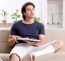 Leg injured young man suffering at home
