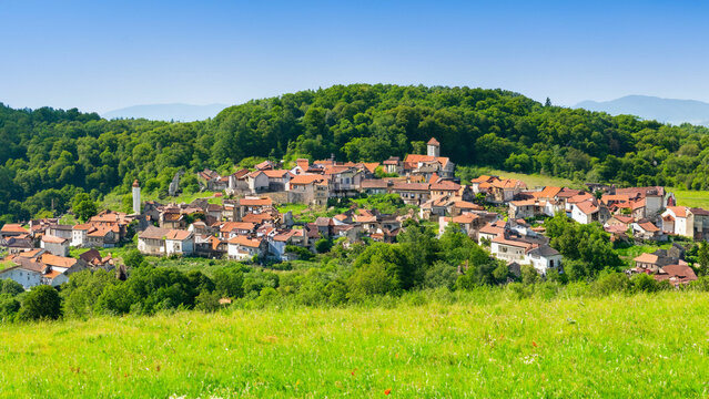 A picturesque village in a lush hilly grassy landscape Generative AI
 