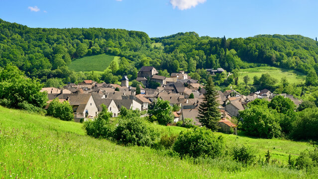 A picturesque village in a lush hilly grassy landscape Generative AI
 