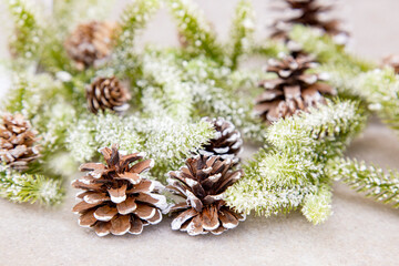 Christmas background with fir tree branches, pine cones and snow. Top view.