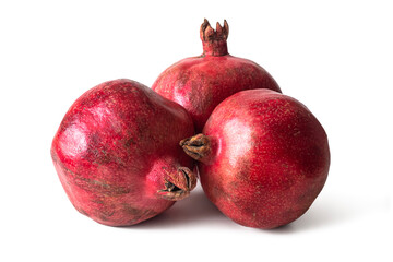 Three ripe red pomegranates on a white background