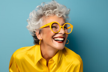 Happy smiling elderly woman portrait in bright clothes isolated on background
