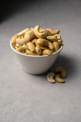 Cashew nuts in a small bowl. Healthy food snack. 