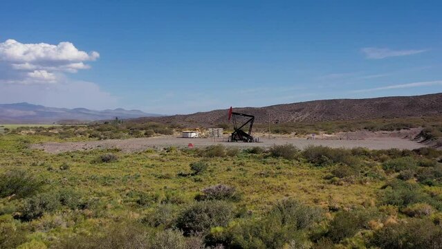 Oil well pumping oil on the desert
