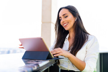 Cheerful business woman smiling in a video conference