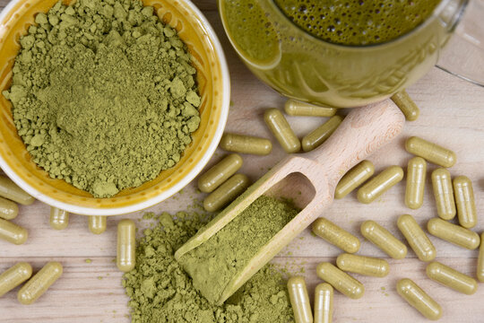 Kratom Mitragyna speciosa powder, capsule and drink top view stock images. Green kratom powder, capsule and beverage still life above stock photo. Kratom herbal medicine stock images