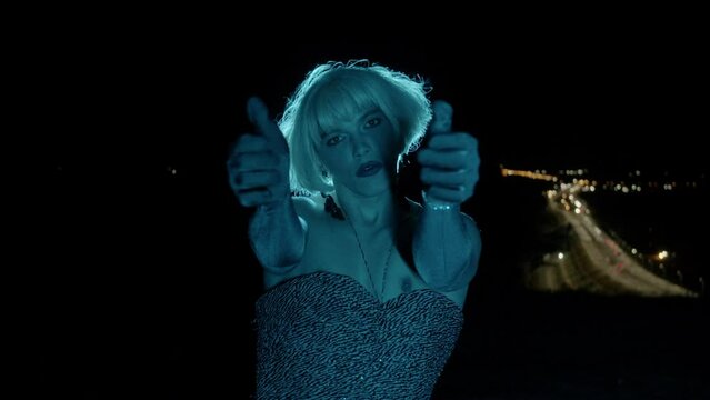 Drag Queen flaunts in front of the camera in blue light
