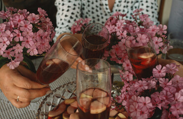 hands with glasses of aperitif together