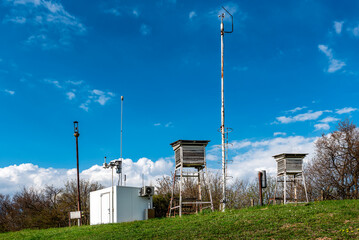 Weather station on the top of the hill in a summer Sunny day.