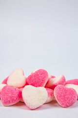 Obraz na płótnie Canvas pile of heart shaped sugar Candies on white background
