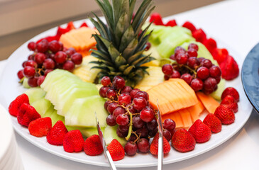 fruits, tomatoes, cheese, and charcuterie on a platter, symbolizing a delectable and balanced culinary experience