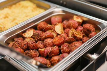 Potluck party with a delightful spread of meat, vegetables, and bread dishes, embodying community and culinary diversity