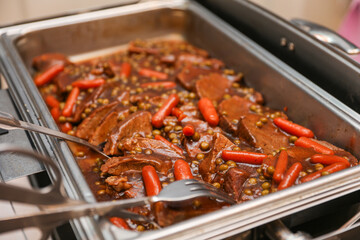 Potluck party with a delightful spread of meat, vegetables, and bread dishes, embodying community and culinary diversity