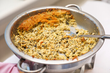 Potluck party with a delightful spread of meat, vegetables, and bread dishes, embodying community and culinary diversity