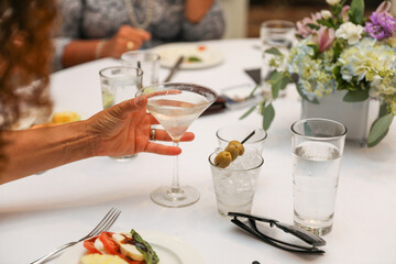 Hands clinking glasses, symbolizing celebration, toasts, and business success with wine, beer, or juice