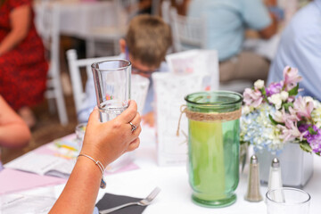 Hands clinking glasses, symbolizing celebration, toasts, and business success with wine, beer, or juice