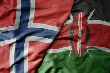 big waving national colorful flag of norway and national flag of kenya .
