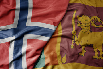 big waving national colorful flag of norway and national flag of sri lanka .