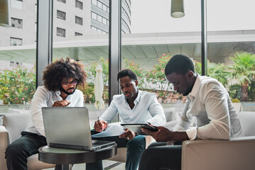 three elegant african-american men at business meeting