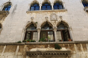 View of traditional colorful croatian windows with flower pots in the windows, in the old town of...