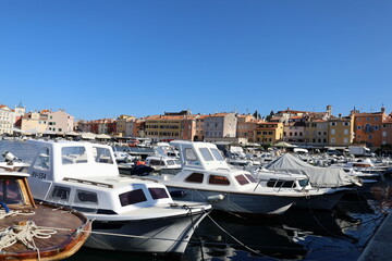 Teddy bear with scooter on the beach looking at sunset 