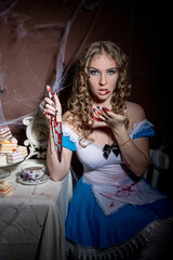Halloween. Portrait of a young woman with a large kitchen knife. Dressed as Alice