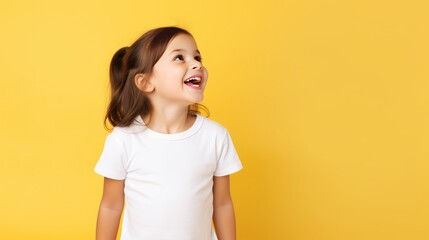 Young little brunette girl posing in white tshirt on yellow background mockup