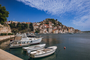 Fototapeta na wymiar Panoramic view to Sibenik old town with boats in front, Sibenik, Dalmatia, Croatia 