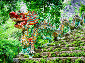 Carved stone dragon stone along the staircase to Hang Mua pagoda and Mua cave, one of the most...