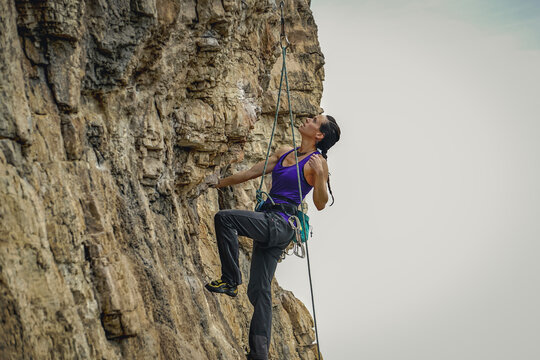 Fearless Female Climber Conquering a Challenging Wall
