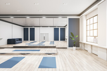 Fototapeta premium Bright group class in gym interior with blue yoga mats, wooden flooring, mirror with reflections, window with city view and daylight. 3D Rendering.