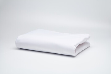 White, neatly folded fabric, mattress cover, sheet. Mattress covers. Production of mattress covers from cotton materials.