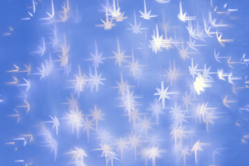 Bokeh as lights white stars on blue background, abstract winter wallpaper with optical blurred...